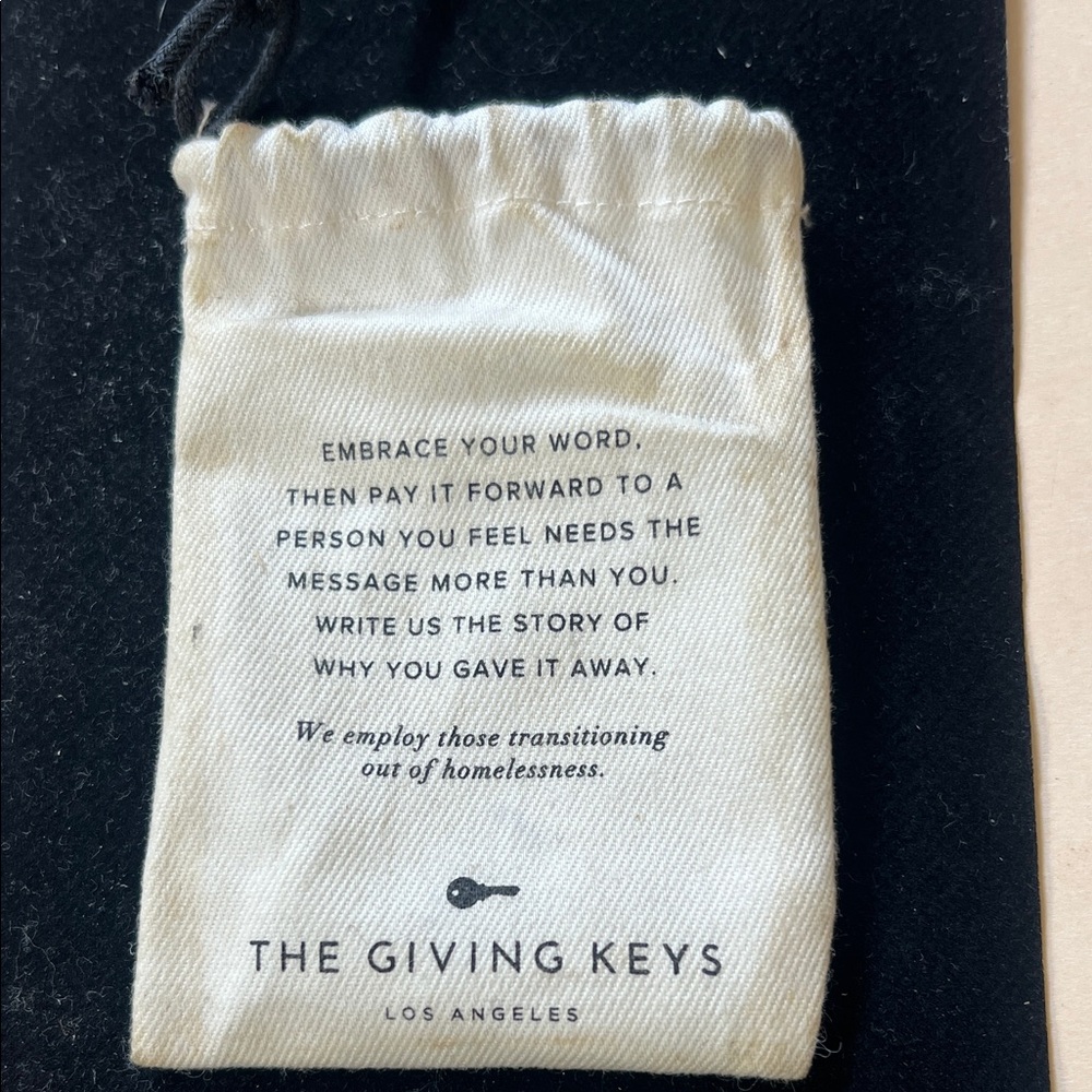 The Giving Keys Inspirational Cream Pouch and necklace